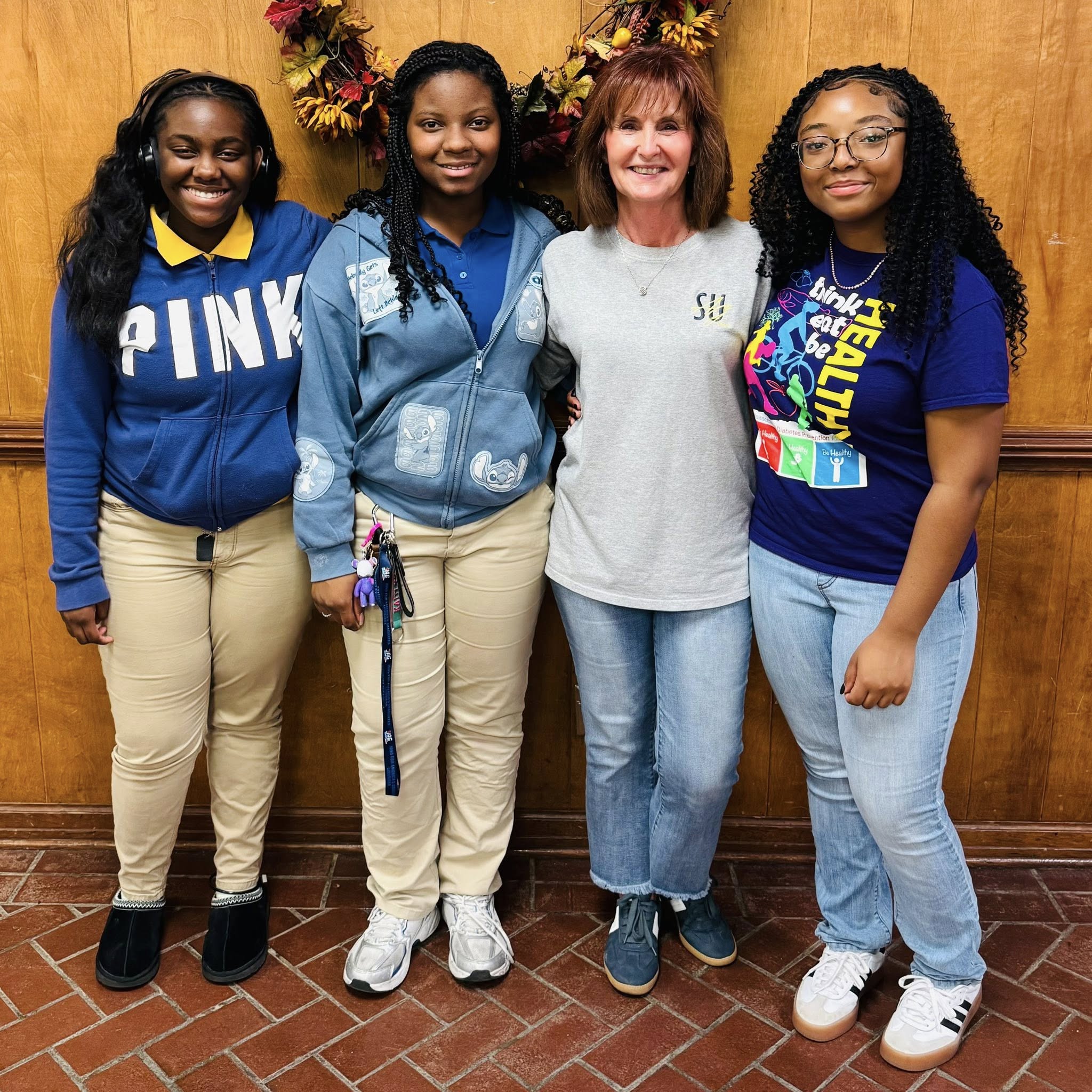 A woman and three girls posing for a photo.